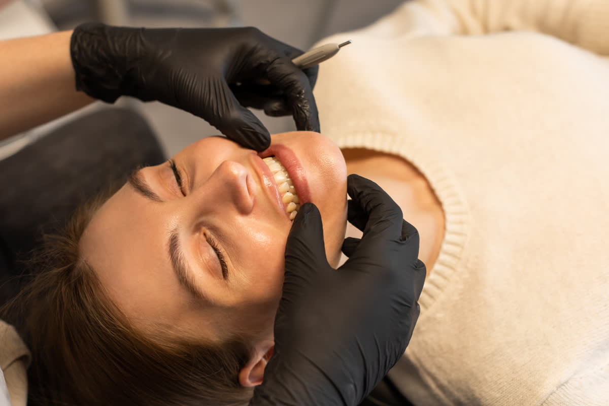 woman getting teeth examined